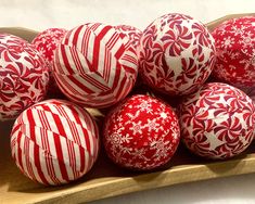 red and white christmas ornaments in a wooden bowl