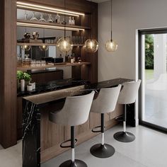 a kitchen with marble counter tops and bar stools in front of an open glass door