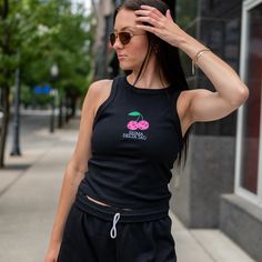 This trendy & unique Disco Cherry Sorority Bella Canvas Embroidered Cropped Tank Top is sure to stand out on any campus! These tanks are perfect for big/little reveal, work-week fits, or bid day celebrations. Matching sweat shorts are available to purchase separately Picture Details ⭑ #1-4: Black tank, White thread (Sigma Delta Tau) (Model wearing size M) *Disco cherry colors cannot be changed Care Instructions ⭑ Wash inside out on cold & air dry for best results ⭑ Do not dry clean ⭑ Light iron Casual Tops With Custom Embroidery For College, Casual Embroidered Tops For College, Cute Tops For College In Spring, Cute Spring College Tops, Black Tops With Custom Embroidery For College, Black Custom Embroidered Tops For College, Black Custom Embroidery Tops For College, Trendy Custom Embroidery Tops For Streetwear, Casual Loungewear Tops With Custom Embroidery