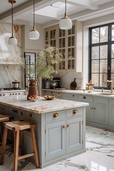 a kitchen with marble counter tops and wooden stools in front of an island that is surrounded by windows