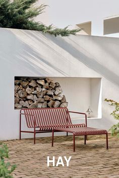 a chair and firewood in front of a house