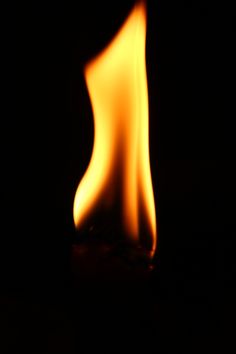 a flame is shown in the dark