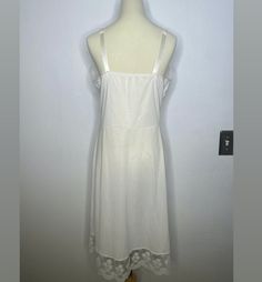 Gorgeous white 60’s lace slip. perfect to lounge in at home adjustable straps labeled a 36 100% Nylon lace floral detailing Best fits a medium. Measurements: length:34” width: 16”bust: 16 1/2“hips:19”Modeled on a small to medium woman Lace Slip, Vintage Lace, White Lace, Sleeveless Dress, At Home, Lounge, Wonder, Lace, Floral