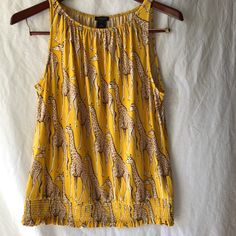 Cute Giraffes Dot This Comfortable Golden Yellow Polyester Jersey. Elasticized Neckline And Bottom. Pit To Pit: 19” Shoulder To Hem: 24” Casual Sleeveless Leopard Print Top, Stretch Sleeveless Leopard Print Top, Casual Leopard Print Sleeveless Tank Top, Mustard Fitted Sleeveless Top, Fitted Mustard Sleeveless Top, Leopard Print Sleeveless Vacation Top, Sleeveless Leopard Print Vacation Tops, Sleeveless Leopard Print Top For Vacation, Mustard Sleeveless Tank Top For Summer