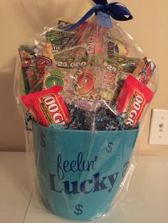 a blue bucket filled with candy and candies