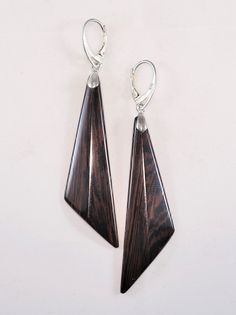 The earrings are one of a kind, handmade from Venge wood and have very smooth and brilliant surface.  Lever backs are Stirling silver . Care instructions: Avoid direct contact with perfumes, alcohol, water and other solvents that may damage wood finish. Wipe jewelry with soft dry cloth. Modern Brown Earrings For Formal Occasions, Elegant Natural Wood Jewelry For Gift, Elegant Brown Wooden Jewelry, Stirling, Wood Earrings, Wooden Jewelry, Wood Finish, Favorite Jewelry, Jewelry Earrings Dangle