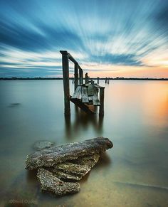 a wooden dock sitting on top of a body of water