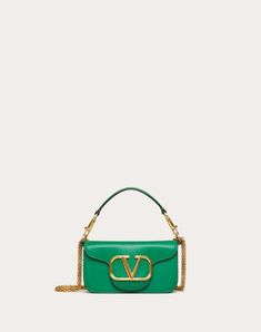 Valentino Garavani Locò women's small shoulder bag in calfskin leather with VLogo Signature metallic element. Equipped with a detachable sliding chain strap and a removable handle, this accessory can be worn as a crossbody/shoulder bag or carried as a handbag. - Antique brass-finish hardware - Magnetic closure - Removable leather handle - Shoulder strap with detachable sliding chain - Nappa leather lining. Interior: one slip pocket Shoulder strap drop length: 55 cm / 21.6 in. - Dimensions: W20xH Jewel Logo, Valentino Purse, Valentino Bags, Designer Shoulder Bags, Boutique Online, Small Shoulder Bag, Boots For Sale, Green Bag, Chain Bags