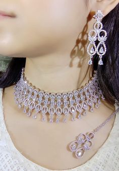 Designer very elegant bollywood inspired CHOKER necklace set with silver finish. It has an adjustable neck thread to suit all types of necks They are a great fashionable traditional added accessory to jazz up any outfit.  Ideal for any upcoming wedding or mehendi or Sangeet party function. A must in every girl's wardrobe!  Postage:  Orders are sent out from the United Kingdom. Gift: Gift packing option with a message is available Return policy  Item is classified under hygiene clause, cannot be Traditional Wedding Choker For Eid, Wedding Necklace With Cutdana For Eid, Pakistani Choker Necklace, Bollywood Style Silver Hand-set Choker, Meenakari Choker Jewelry Sets For Gifts, Mang Tika, Pakistani Jewellery, Jewellery Bridal, Jewellery Wedding