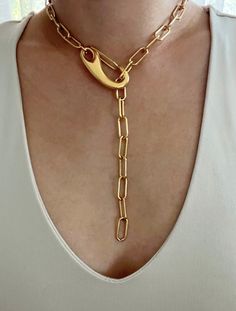 Chunky gold paperclip lariat featuring a large clasp. Necklace can clasp anywhere on the chain for different looks. Necklace is gold plated stainless steel. It is of great importance to me that I make jewelry for my customers that I, myself, wear every day. Each jewelry piece is handmade by me personally with love and care. Each item is crafted to the highest quality and made to exceed the expectations of my customers. My jewelry is designed to you to love and wear no matter what the occasion at Metal Lariat Necklace With Chunky Chain, Chunky Chain Metal Lariat Necklace, Chunky Chain Lariat Necklace, Gold Paperclip Necklace With Hooks And Links, Gold Chain Link Lariat Necklace, Metal Lariat Necklace With Chain, Metal Lariat Necklace With Chain Detail, Metal Lariat Necklace, Everyday Gold Lariat Necklace With Lobster Clasp