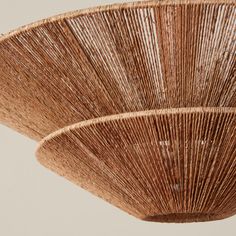 a close up view of the top of a bamboo fan hanging from a ceiling fixture