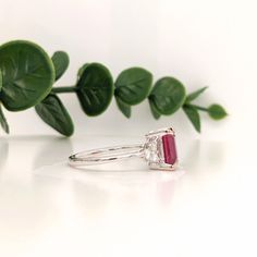 This beautiful ring features an emerald-cut ruby with a triad of natural earth-mined diamonds on both sides, all set in solid 14K white gold. This ring can be a lovely July birthstone gift for your loved ones! This ring is made with solid 14K Gold and naturally Earth-mined SI / G-H diamonds. If you're interested in purchasing this setting with a different center stone please message us! Luxury Emerald Cut Lab-created Ruby Rings, Fine Jewelry Ruby Ring With Radiant Cut Center Stone, Fine Jewelry Ruby Ring With Radiant Cut Diamond, Radiant Cut Ruby Ring In Fine Jewelry Style, Luxury Emerald Cut Ruby Promise Ring, Radiant Cut Ruby Ring Fine Jewelry, Radiant Cut Ruby Ring With Center Stone, Asscher Cut Ruby Ring With Diamond, Gia Certified Emerald Cut Ruby Ring