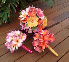 a bouquet of flowers sitting on top of a wooden table next to a pair of scissors