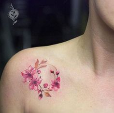 a woman's chest with pink flowers on it