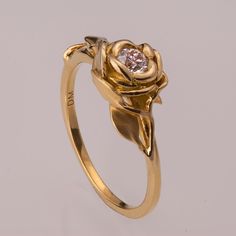 "A handmade 14k gold ring showing a natural rose set with a beautiful 0.2ct clear diamond. The rose is surrounded by a composition of leaves giving the ring a very natural look. This ring is set with a clear diamond but can be set with any stone you choose, please contact me for a quote. Diamond - Weight - Choose at the variation menu Color - G Clarity - SI This engagement ring can be worn as a set with one of these matching bands - https://www.etsy.com/listing/126200242/ https://www.etsy.com/li Quinceanera Rings, قلادات متدلية, The Bling Ring, Gold Jewelry Simple Necklace, Gold Bride Jewelry, Gold Rings Fashion, Gold Ring Designs, Gold Rings Jewelry, Gold Jewelry Simple