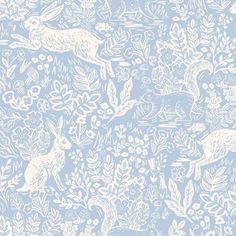 a blue and white wallpaper with deers in the woods on it's side