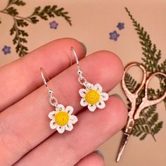 White and yellow daisy flower earrings, micro crocheted with a 0.4mm crochet hook and cotton thread, finished with 925 sterling silver earrings hooks 🌼 This item makes a perfect gift for lovers of flowers, dainty jewellery, nature, cottagecore accessories and handmade or crochet jewellery. Each pair are handmade to order so you know that you are getting something that's completely unique from a handmade crafter. ❤️ Perfect for nature lovers, wildflower lovers or those looking for the perfect cottagecore aesthetic 🌻 These earrings are available with either full 925 sterling silver earring hooks or 925 silver plated earring hooks, it's up to you! All orders come with a free silver polishing cloth to keep your jewellery shiny and lustrous 😊🌸 Delicate Handmade Flower Earrings For Summer, Summer Daisy Flower Earrings Gift, Handmade Daisy-shaped Earrings For Gifts, Handmade Daisy-shaped Earrings As Gift, Handmade Daisy Earrings As Gift, Handmade Daisy Shaped Earrings As Gift, Handmade Dainty Flower Earrings For Spring, Handmade Dainty Flower Earrings For Summer, Dainty Handmade Earrings For Spring