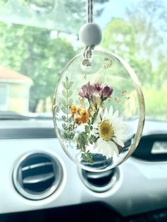 a car dashboard with flowers hanging from it's side