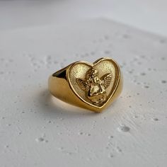 This ring is shaped like a heart, featuring the image of Cupid. It has a romantic feel and impeccable quality. Material: Stainless Steel. Finish: 18k Gold Plated. 🔸more from us🔸 https://www.etsy.com/shop/DoraJewelryAccessory Chunky Heart Ring, Chunky Gold Rings, Melted Gold, Angel Ring, Tarnished Jewelry, Gold Rings Jewelry, Nice Outfits, Waterproof Jewelry, Ring Vintage