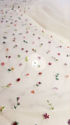 the bed is covered with many different colored flowers