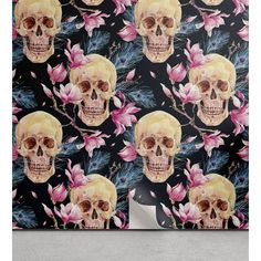 a wall with skulls and flowers on it