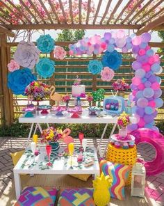 an outdoor party with balloons and decorations