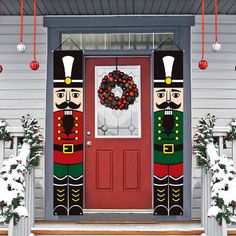 the front door is decorated with nutcrackers and wreath