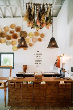 a room filled with wooden furniture and hanging lights