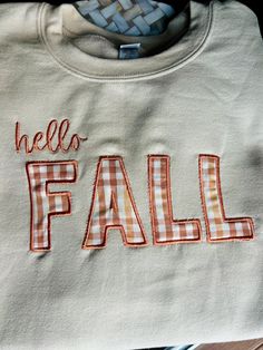 a white shirt that says hello fall on it