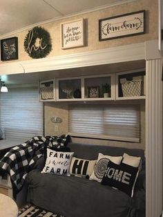 a living room filled with furniture and pictures on the wall above it's windows