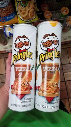 two cans of pringles are shown in a store