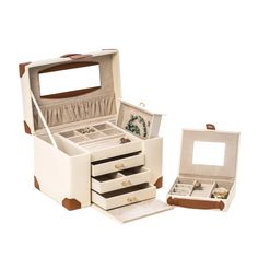 an open white jewelry box with two drawers and one drawer on the bottom, next to it's contents