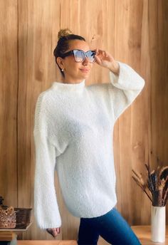 "This handmade white mohair sweater is super soft, chic and comfy! It is 100% hand knitted from mohair wool.  COMPOSITION  * Soft and airy mohair * Drop shoulders * Not itchy wool SIZE This sweater in the photos is suitable for those who wear between M and L. Please check its dimensions below to understand if it fits your size! -Chest:   25,6\" (65 cm) -Sleeve:  22.4\" (57 cm) -Length: 27.5\" (70 cm) *The model in photos is 67\"/170 cm, size M. 📦NEW ORDERS If you need custom size or color, plea Chic White Mohair Sweater, White Fluffy Sweater, Chunky White Sweater, Cream Mohair Chunky Knit Sweater, White Mohair Sweater, Elegant White Mohair Sweater, Cozy White Mohair Sweater, White Wool Sweater, Long White Sweater