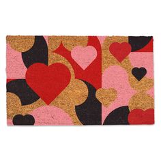 a door mat with hearts on it in pink, red and black colors is shown