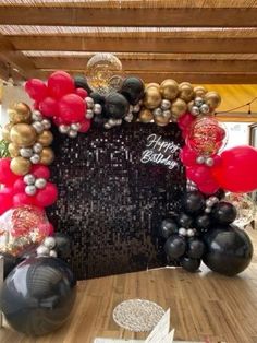 balloons and streamers are on the table for a birthday party