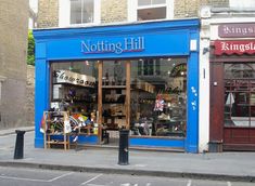 a blue store front on the corner of a street