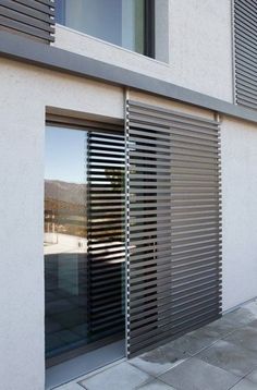 an exterior view of a building with windows and shutters