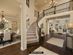 a living room filled with furniture and a staircase