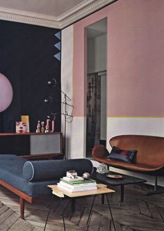 a living room filled with furniture and a painting on the wall