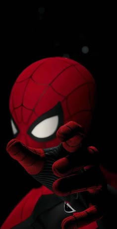 a spider - man with his hands on his face and eyes closed, in front of a black background