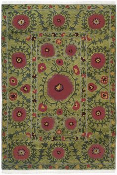 a green rug with red and yellow flowers on the center, surrounded by smaller circles