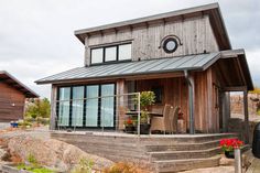 a small wooden house sitting on top of a rocky hillside