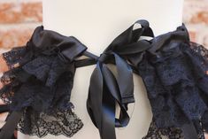 a mannequin with black lace and bows on it