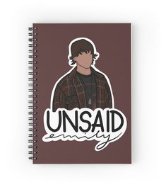 a spiral notebook with the words unsaid on it and an image of a young man