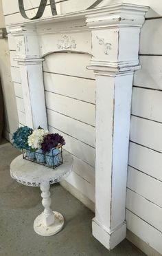 a white table with flowers on it in front of a sign that says q & o