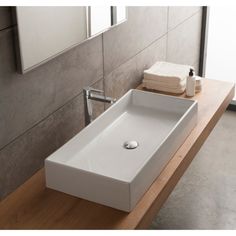 a white sink sitting on top of a wooden counter