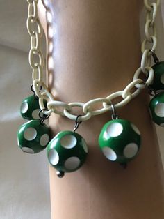 "Very cute fun costume jewelry from the 1940's-50's. Plastic chain link could be celluloid or maybe Bakelite. Little green and white dotted balls are possible the same. Playful costume jewelry from the 1940's. Measurements are; From end to end 17\" Feel free to convo me with any further questions. Thank you for your interest." 1950s Casual Jewelry, Cheap Retro Plastic Jewelry, Retro Handmade Plastic Jewelry, Adjustable Retro Jewelry, Retro Bakelite Jewelry As Gift, Handmade Retro Bakelite Jewelry, Vintage Plastic Jewelry For Gifts, Retro Lucite Jewelry As Gift, Handmade Retro Green Jewelry