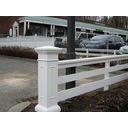 a white fence with cars parked in the background