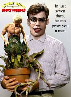 a man holding a potted plant with a doll in it