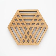 a wooden object that looks like a hexagonal structure on a white surface with no background